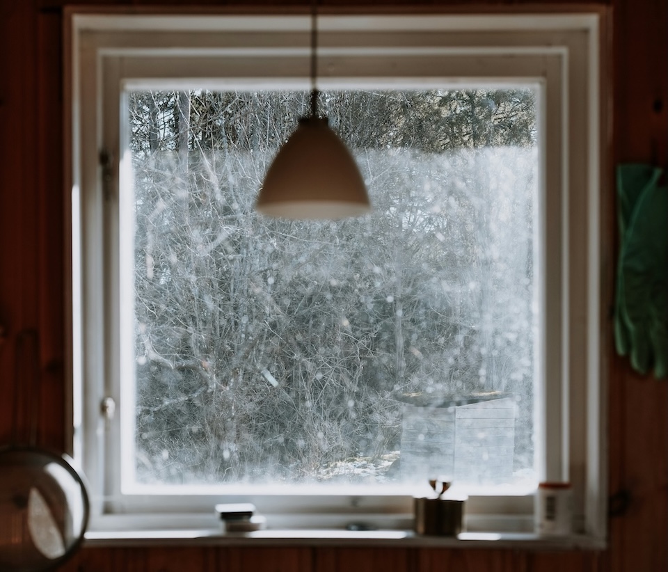 large window in window overlooking forest in winter